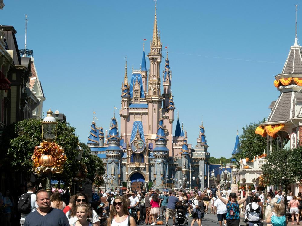 Visitors walk along Main Street at Walt Disney World's Magic Kingdom in September 2022. Last week, Florida Gov. Ron DeSantis signed a bill to move Disney World's special tax district under quasi-government control.