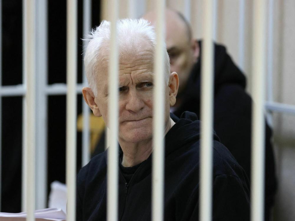 Nobel Prize winner Ales Bialiatski is seen in the defendants' cage in the courtroom at the start of the hearing in Minsk on Jan. 5, 2023