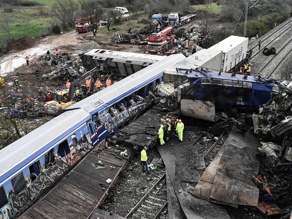 Police and emergency crews examine the debris of a crushed wagon on the second day after a train accident in the Tempi Valley near Larissa, Greece, March 2, 2023.