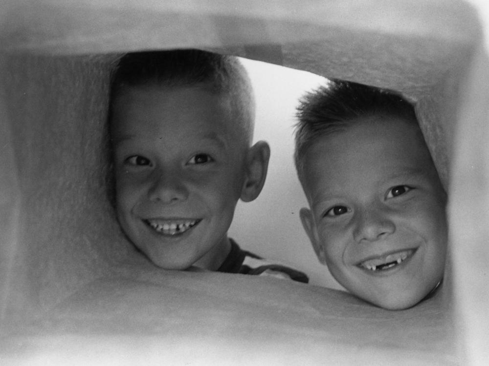 Circa 1955: Bobby, whose two front teeth dropped out recently, with his twin brother Jerry.