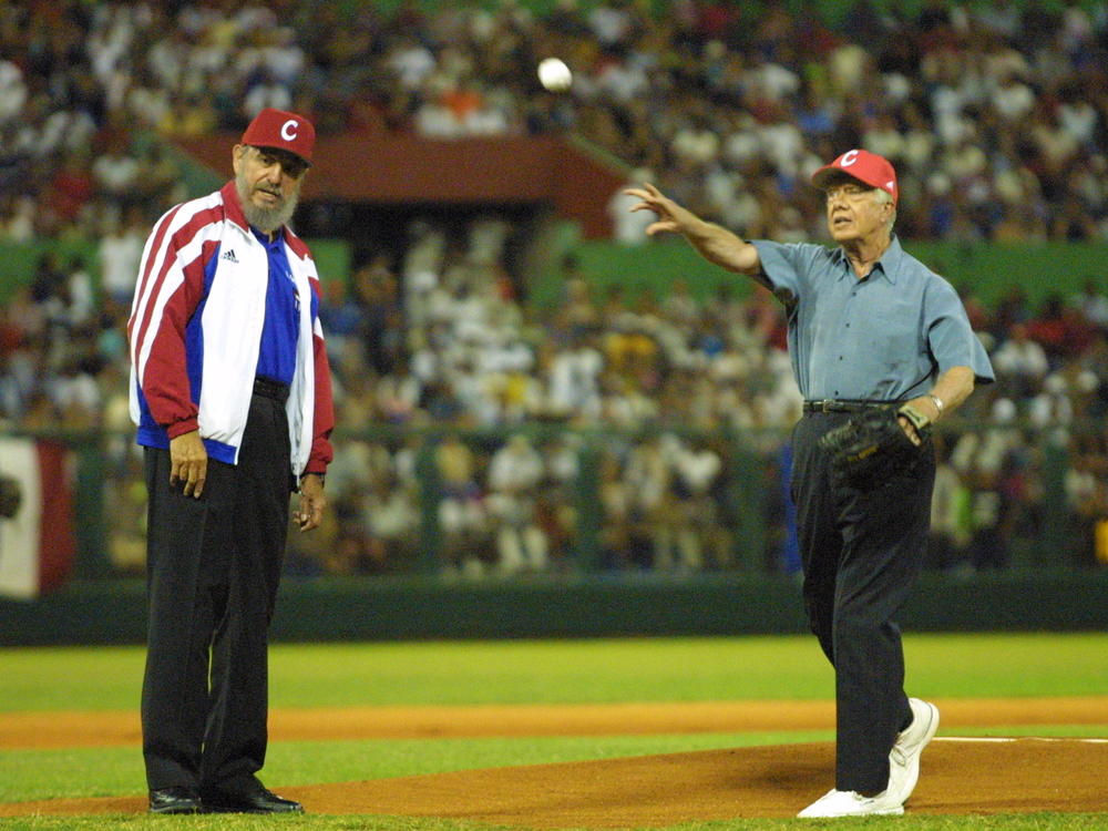 May 14, 2002: Cuban President Fidel Castro watches former US President Jimmy Carter throw a baseball prior to the start of a a friendly baseball match between two Cuban teams in Havana, Cuba. At the time, Carter was the first U.S. President, in or out of office, to visit communist Cuba since the 1959 revolution that put Castro in power.