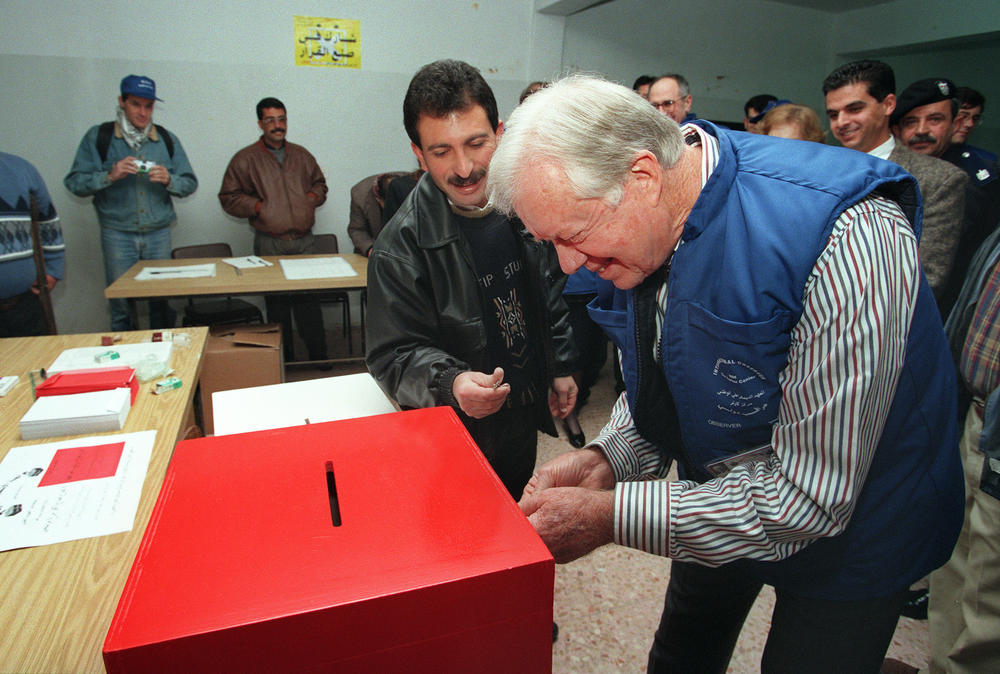 January 20, 1996: Former US President Jimmy Carter checks a ballot box in the Daheisha refugee camp in the West Bank. Carter was heading a international delegation to observe the Palestinian elections.