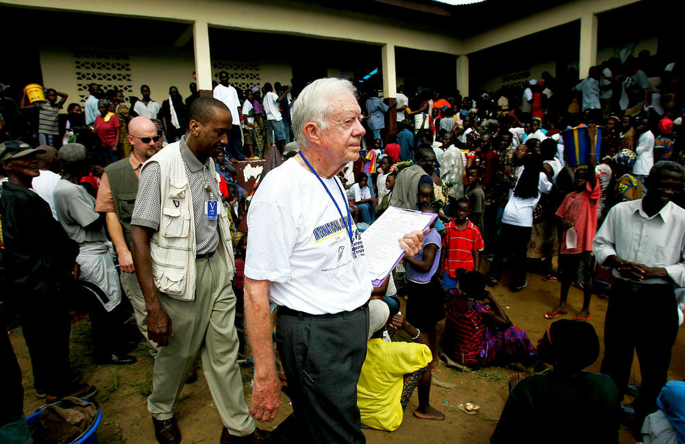 October 11, 2005: Former U.S. President Jimmy Carter exits a polling site in Monrovia, Liberia. The Carter Center, founded by Carter to promote peace initiatives and health issues worldwide, is in Liberia to monitor the elections along with the National Democratic Institute.