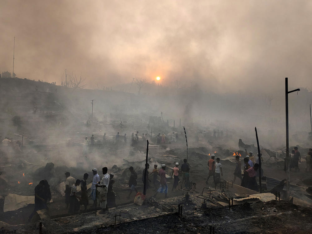 Rohingya refugees try to salvage their belongings after a major fire in the heavily cramped Balukhali camp.
