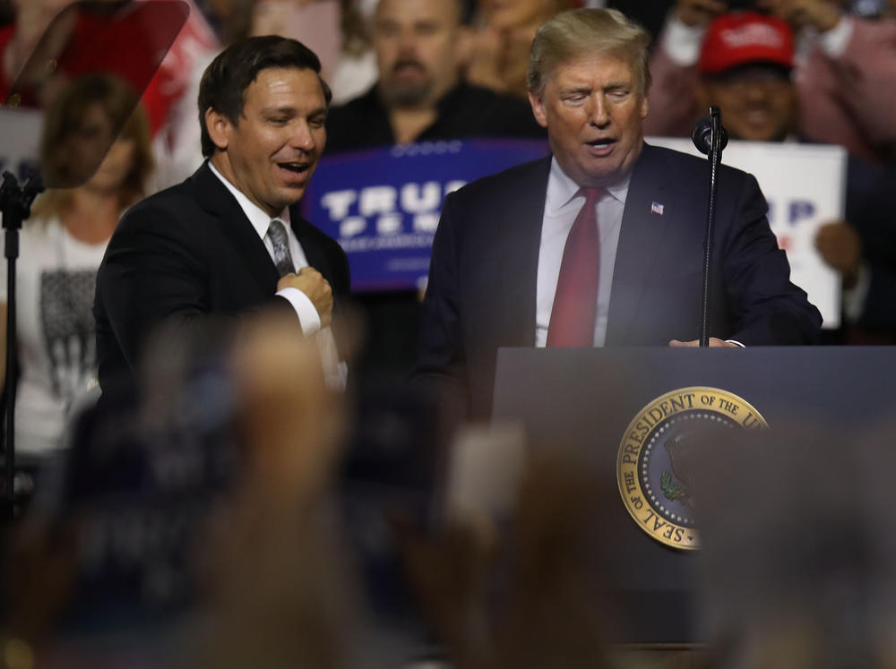 President Donald Trump stands with GOP Florida gubernatorial candidate Ron DeSantis during the president's Make America Great Again Rally at the Florida State Fair Grounds Expo Hall on July 31, 2018 in Tampa.