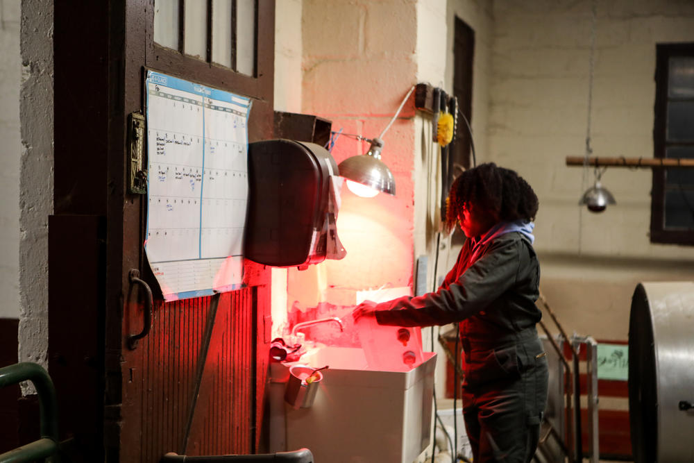 April Majors, 26, a student at UMD, gets the container with bucket teat unit ready to feed the lambs who have struggled to get milk from their mother.