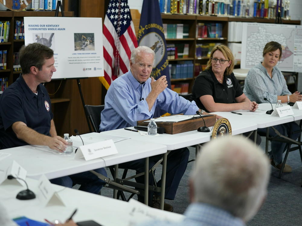 President Biden gets a briefing in Lost Creek, Ky., after touring flood damage. He vowed that communities in the state would get help to rebuild after the disaster.