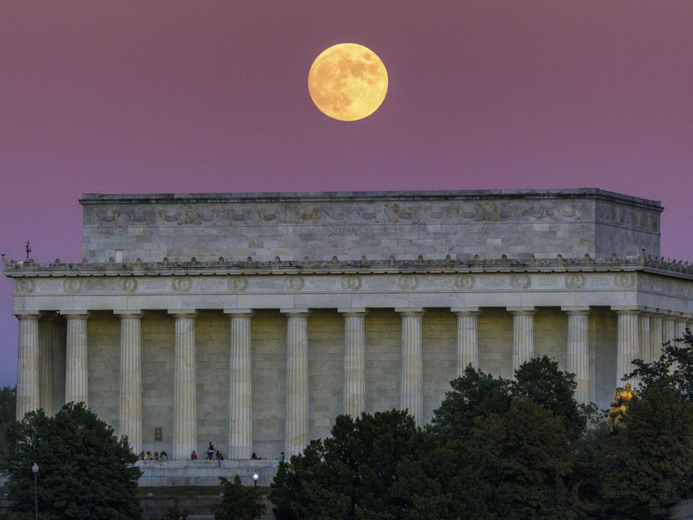 The full moon, also called the Beaver Moon, rises above the Lincoln Memorial at sunset in Washington, Monday, Nov. 7, 2022.
