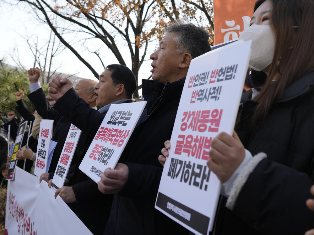 Members of civic groups shout slogans during a rally against the South Korean government's announcement of a plan over the issue of compensation for forced labors, in front of the Foreign Ministry in Seoul, South Korea, Monday, March 6, 2023.