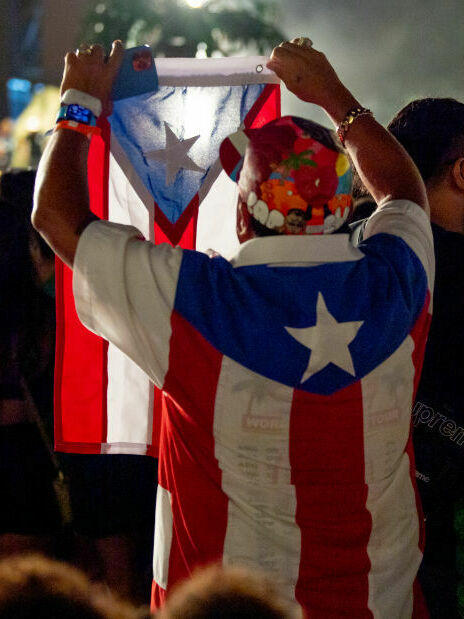 Member of the audience wears a Puerto Rico flag as Bad Bunny performs at Yankee Stadium in 2022.