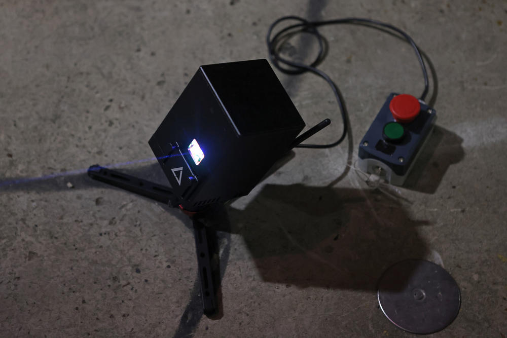 Members of the white nationalist group National Socialist Florida use a laser projector in an alleyway to display white nationalist and anti-LGBTQ images on the sides of high-rise buildings in Jacksonville, Florida.