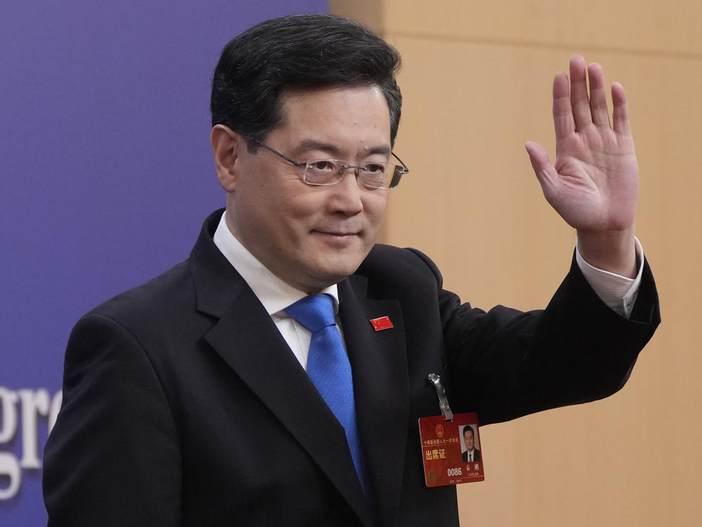 Chinese Foreign Minister Qin Gang waves as he arrives for a press conference held on the sidelines of the annual meeting of China's National People's Congress (NPC) in Beijing, Tuesday, March 7, 2023.