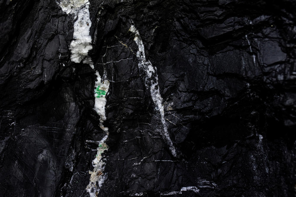 Emeralds encrusted in white calcite rock inside the mine at Muzo in central Colombia. They will later be analyzed at a laboratory to determine their worth.