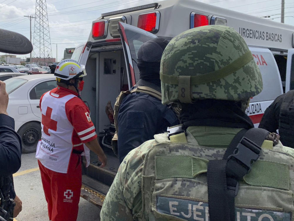A Red Cross worker closes the door of an ambulance carrying two Americans found alive after they were abducted in Matamoros, Mexico, last week. Two of four Americans have been found dead, after they were caught in a cartel shootout, officials said Tuesday.
