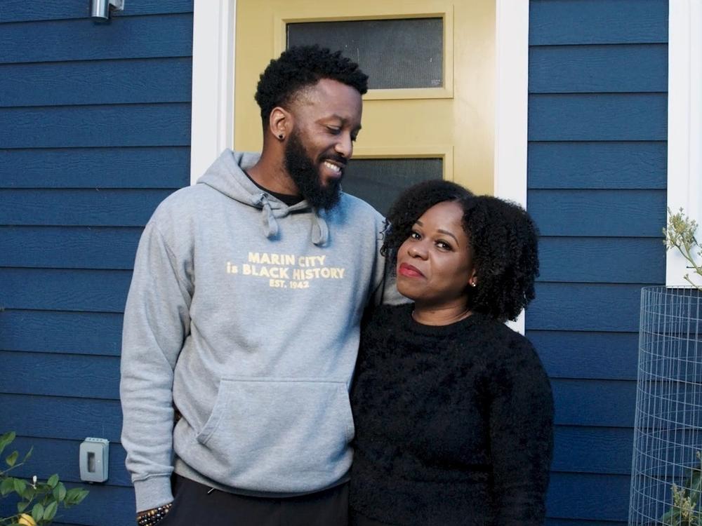 Paul Austin and Tenisha Tate Austin stand in front of their renovated home in Marin City, Calif. The couple settled a federal housing discrimination lawsuit late last month.