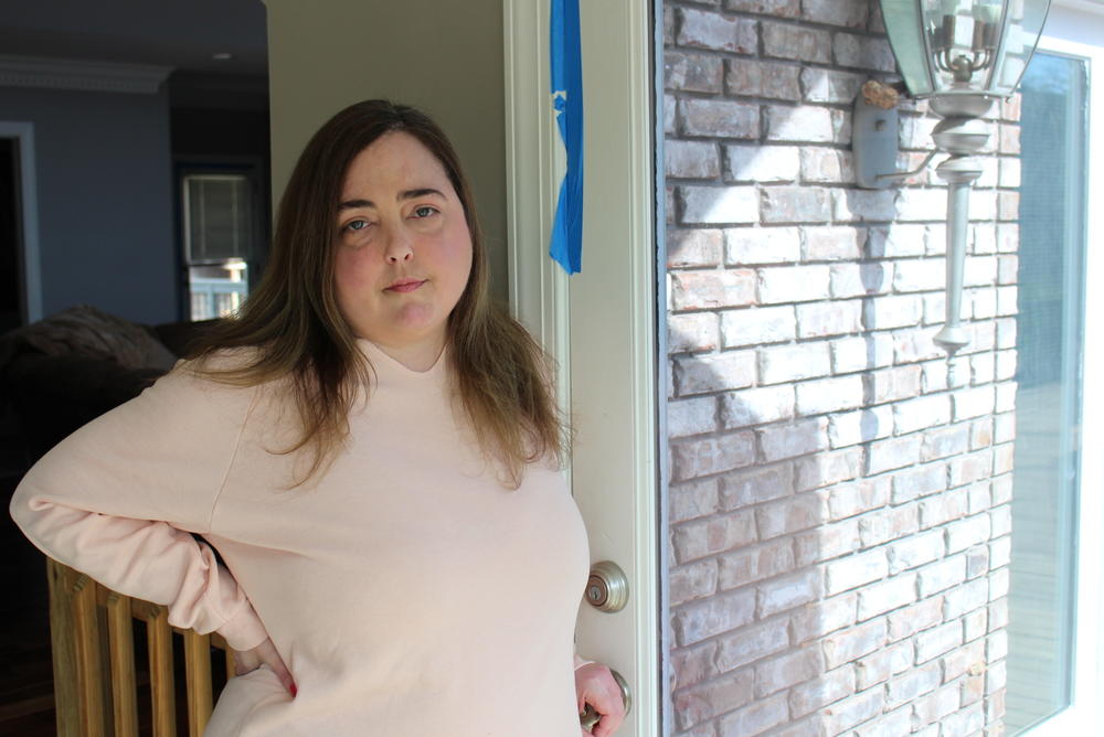 Krissy Harmon's home is less than a mile from a landfill that caught fire more than three months ago. She uses blue painter's tape to keep smoke out and says her family still experiences health issues brought on by the fire.