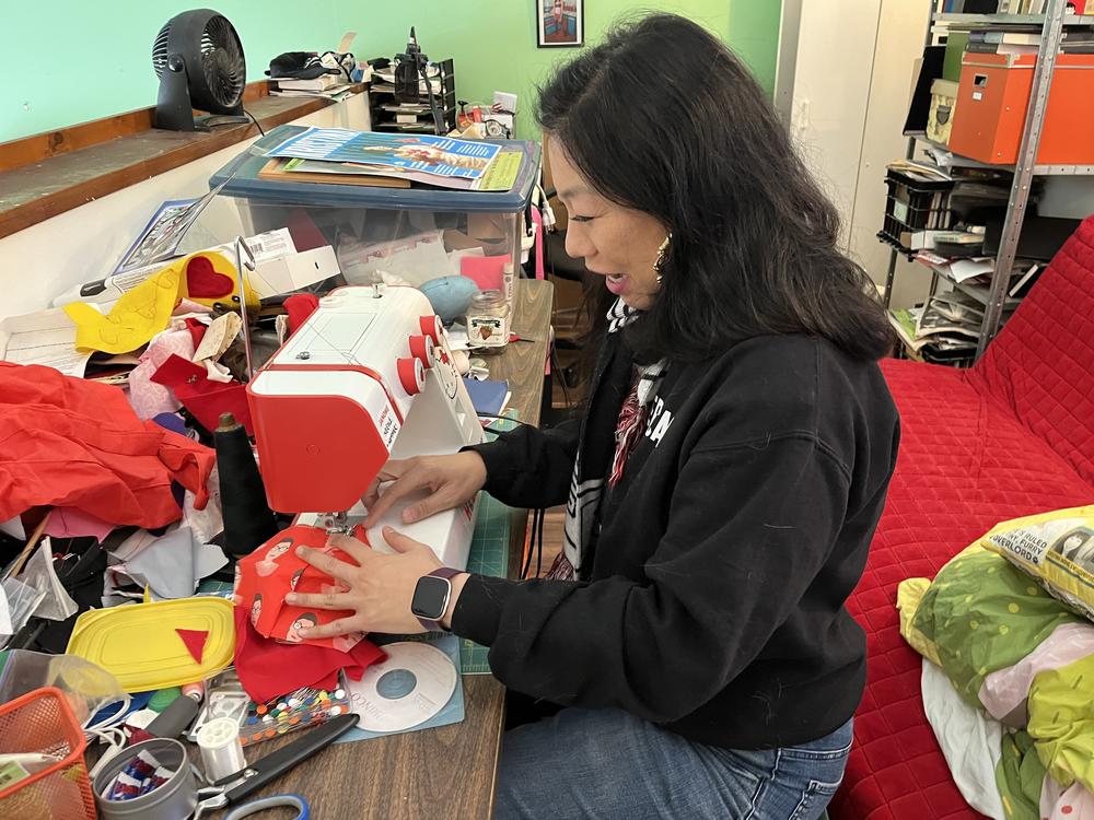 Kristina Wong demonstrates how to make a mask at the Hello Kitty Sewing machine in her Koreatown, Los Angeles apartment.