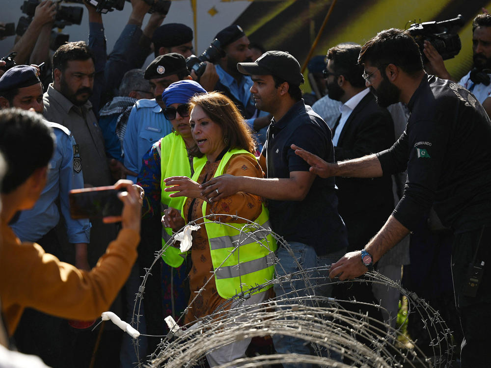 Policemen try to stop activists during a rally to mark International Women's Day in Islamabad on March 8 — and demand equal rights for women in Pakistan. Thousands of women took part in rallies across the country despite efforts by authorities in several cities to block the marches.