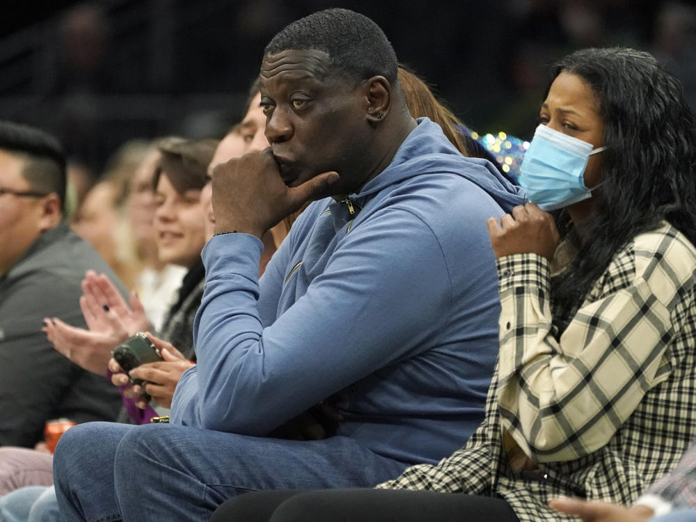 Former Seattle SuperSonics forward Shawn Kemp (center) was booked into jail Wednesday, on a felony charge stemming from a shooting. He's seen here last year, at a WNBA game between the Seattle Storm and the Chicago Sky.