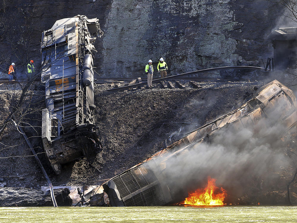 Smoke fills the sky after an empty CSX coal train hit a rockslide along tracks causing a fiery derailment, Wednesday, March 8, 2023, in a remote area just south of Sandstone, W.Va.