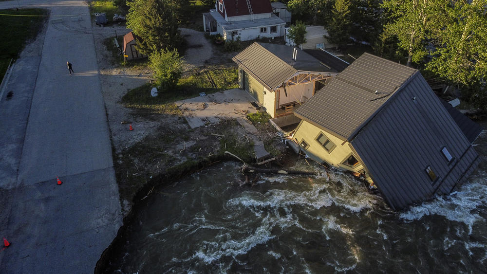 A house sits in Rock Creek in June 2022 after floodwaters washed away a road and a bridge in Red Lodge, Mont.