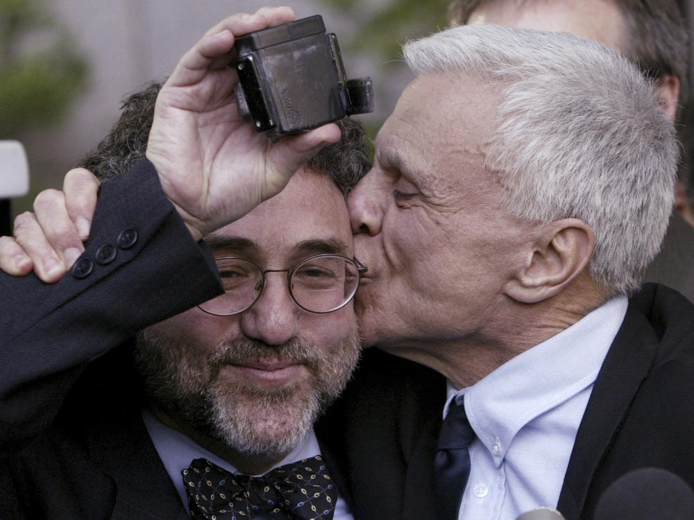 Robert Blake, right, kisses his attorney M. Gerald Schwartzbach as Schwartzbach holds up Blake's ankle monitor after Blake was found not guilty in his murder trial for the death of his wife Bonny Lee Bakley in Los Angeles, March 16, 2005.