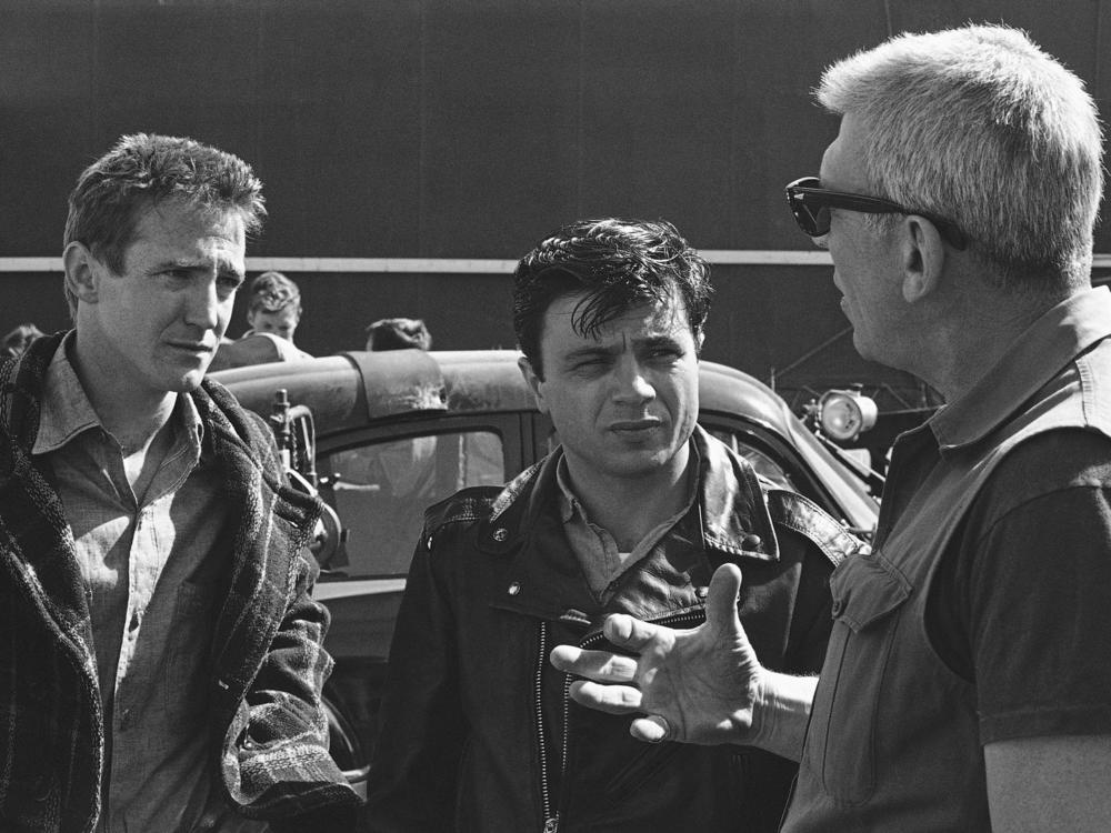 Director Richard Brooks, right, makes a point while talking to actors Scott Wilson, left, and Robert Blake during filming of the adaptation of the book 