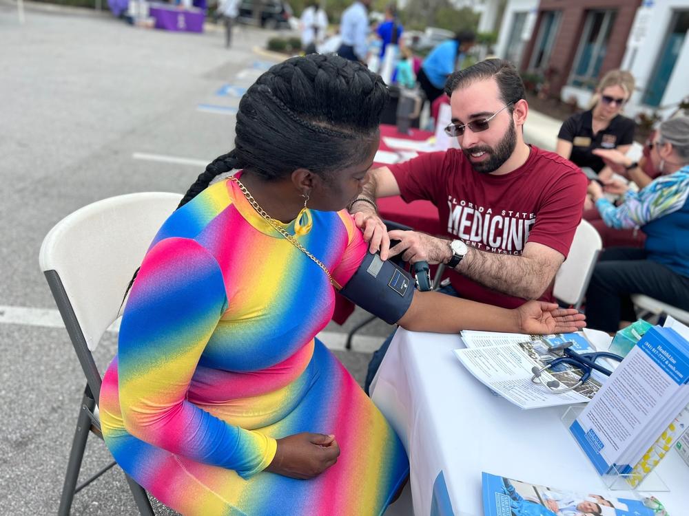 Substitute teacher Crystal Clyburn, 51, doesn't have health insurance. She got her blood pressure checked at a health fair in Sarasota, Fla.