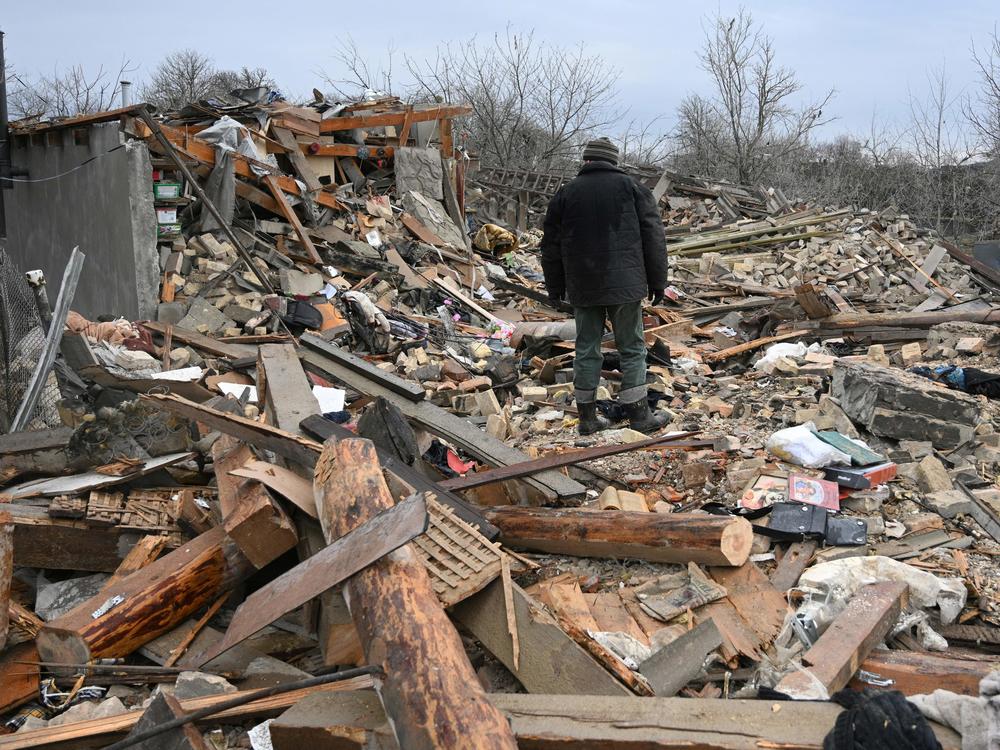 People search the rubble of a house following a Russian strike in the village of Velyka Vilshanytsia, near the city of Lviv in Western Ukraine, on Thursday.