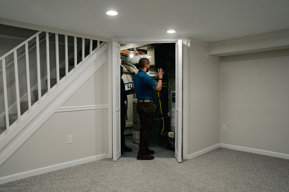 Appraiser trainee Devin Minnis inspects a house in Baltimore. He says he's lucky to have a supervisor who's Black like him in an industry where some 90% of U.S. appraisers are white.