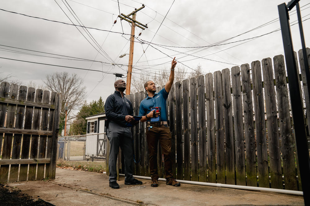 Real estate appraiser Jack Sonceau (left) and his trainee, Devin Minnis, assess a house in Baltimore.