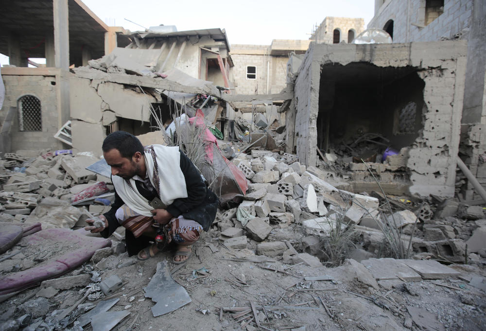 A man holds debris from the rubble of houses destroyed by Saudi-led airstrikes in Sanaa, Yemen, June 9, 2017.