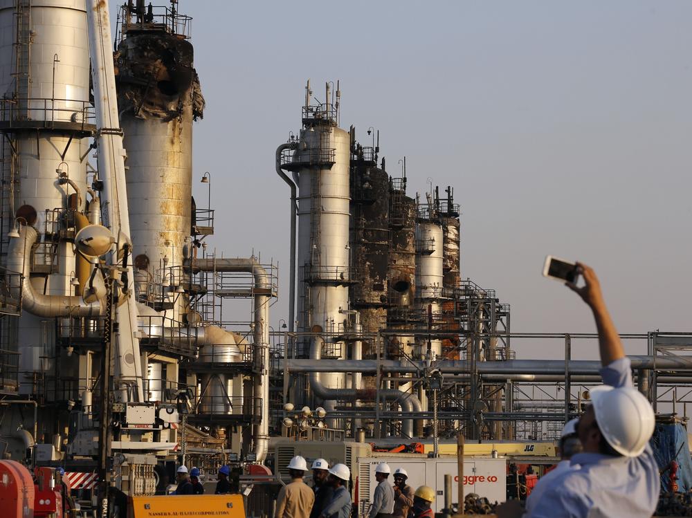 A man films Aramco's oil processing facility after the Sept. 14, 2019, attack in Abqaiq, near Dammam in eastern Saudi Arabia.