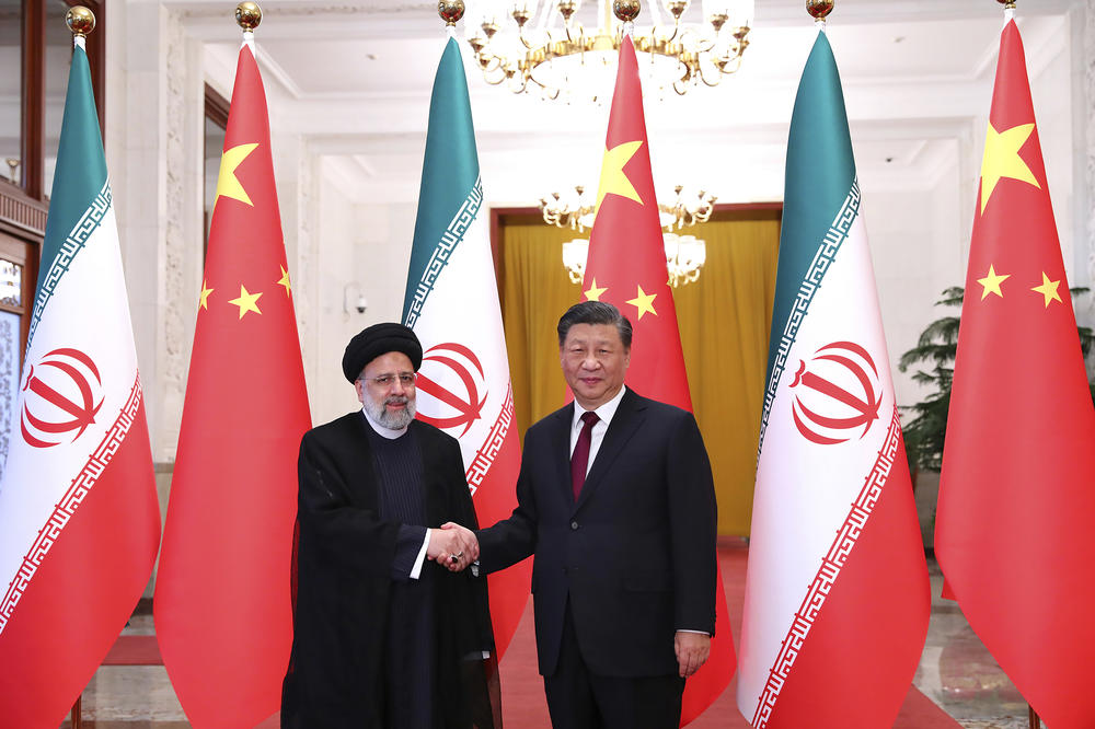 Iranian President Ebrahim Raisi (left) shakes hands with Chinese leader Xi Jinping in an official welcoming ceremony in Beijing, Feb. 14.