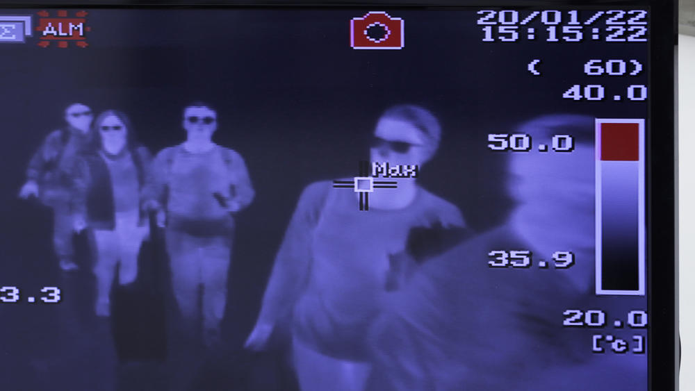 Airports began taking measures to identify infected passengers early on. A monitor displays images of a thermal scan of passengers at Narita Airport in Japan on Jan. 22, 2020.