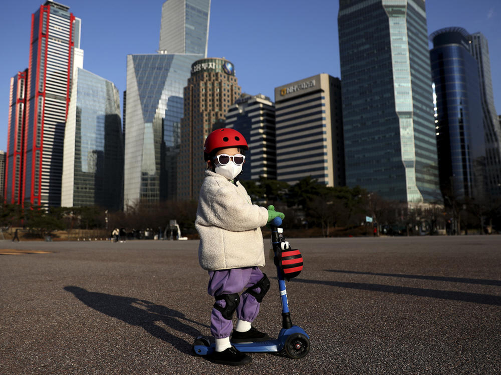A South Korean child masks up to ride a scooter on Feb. 27, 2020 in Seoul.