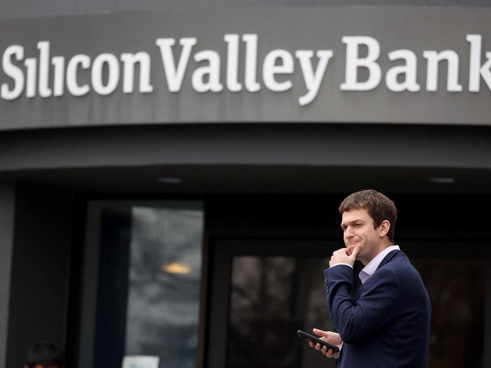 A customer stands outside of the shuttered Silicon Valley Bank headquarters in Santa Clara, Calif., on March 10, 2023. The lender was taken over federal regulators on Friday, marking one of the largest bank failures since the 2008 Global Financial Crisis.
