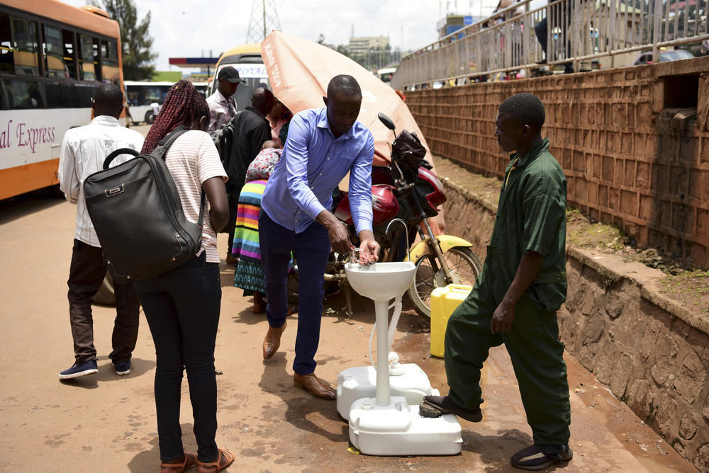 A public hand-washing station for passengers boarding a bus was set up as a cautionary measure against the coronavirus at Nyabugogo Bus Park in Kigali, Rwanda. The photo was taken on March 11, 2020.