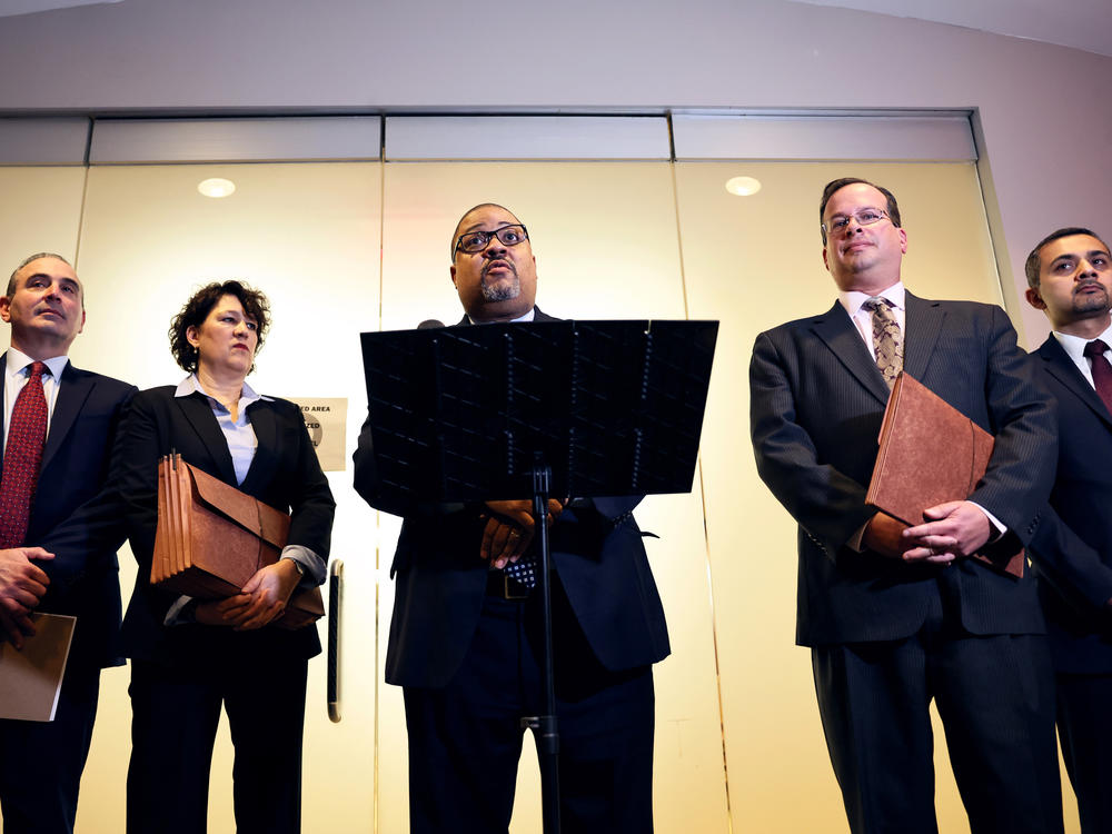 Manhattan District Attorney Alvin Bragg speaks at a press conference in January, after a sentencing hearing of the Trump Organization. Bragg's office has invited former President Trump to testify before a grand jury — a step that often precedes an indictment.