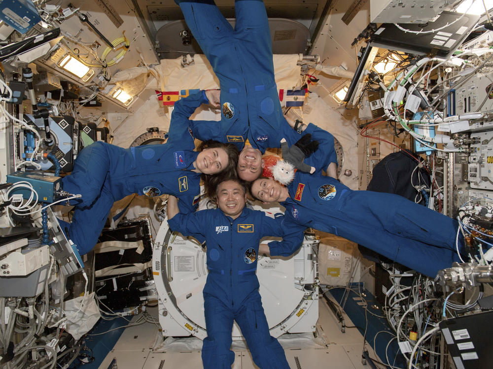 Expedition 68 Flight Engineers, pictured clockwise from left, Anna Kikina of Roscosmos, Josh Cassada and Nicole Mann from NASA, and Koichi Wakata of JAXA (Japan Aerospace Exploration Agency) gather for a portrait inside the International Space Station's Kibo laboratory module on March 1.