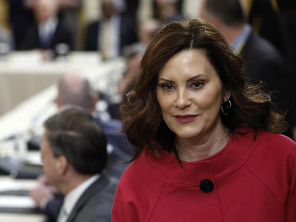 Michigan Gov. Gretchen Whitmer walks to her seat at a meeting between President Biden and governors from around the country at the White House on Friday. Whitmer and Biden were both mentioned in alleged threats made by a Michigan man arrested on firearms charges.