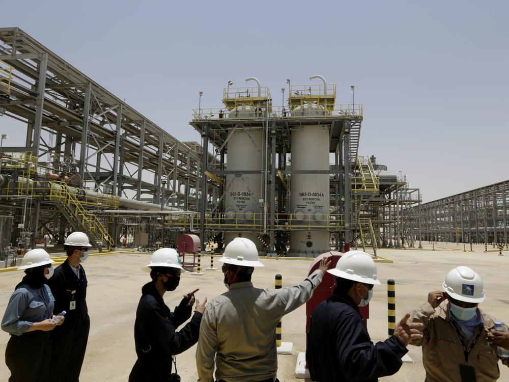 Saudi Aramco engineers and journalists look at the Hawiyah Natural Gas Liquids Recovery Plant in Hawiyah, in the Eastern Province of Saudi Arabia on June 28, 2021.