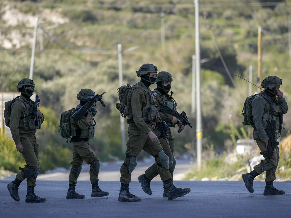 Israeli soldiers operate in village of Sarra near the Palestinians West Bank city of Nablus, Sunday, March 12, 2023. Israeli forces fatally shot three Palestinian gunmen who opened fire on troops in the occupied West Bank. It was the latest bloodshed in a year-long wave of violence in the region.