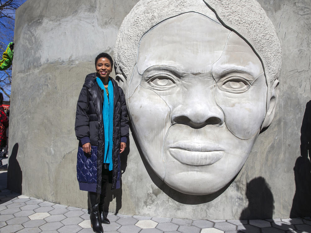 Architect Nina Cooke John stands with the Harriet Tubman monument she designed titled 