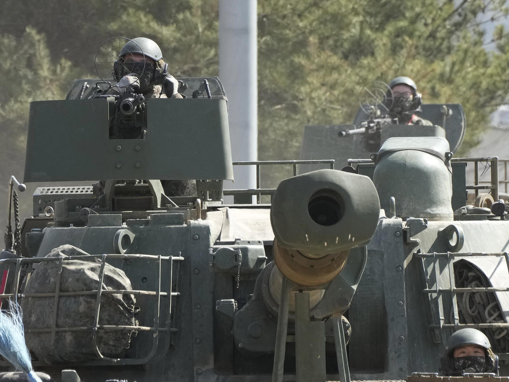 South Korean army soldiers ride K-5 self-propelled howitzers in Yeoncheon, South Korea, near the border with North Korea, Monday, March 13, 2023.