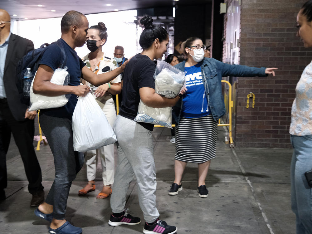 Migrants are directed through Manhattan's Port Authority bus station last August.