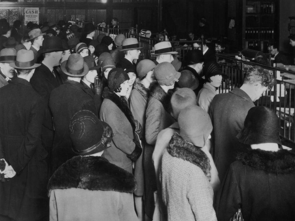 Investors rush to withdraw their savings during a stock market crash, circa 1929.