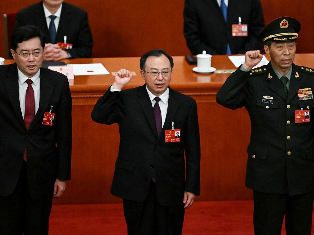 Uniformed Li Shangfu, far right, is shown swearing an oath with other officials after they were elected during the fifth plenary session of the National People's Congress at the Great Hall of the People in Beijing on March 12, 2023.