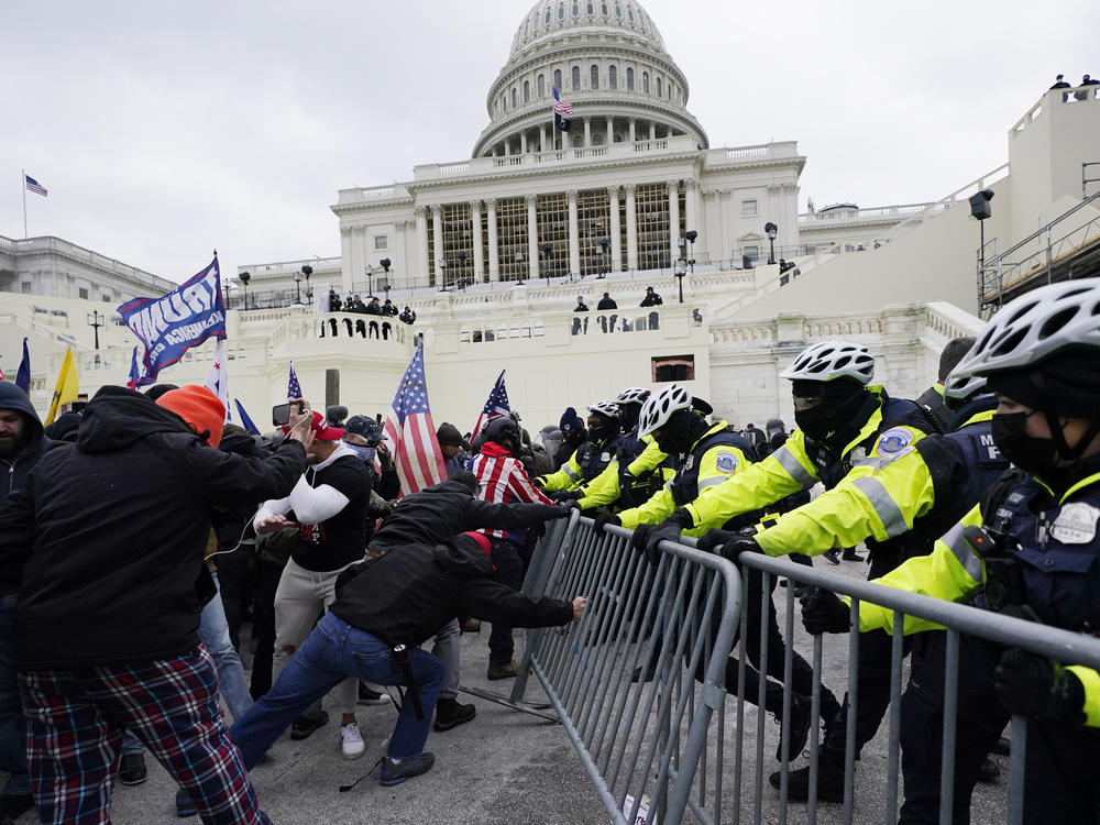 Insurrectionists loyal to President Donald Trump try to break through a police barrier on Jan. 6, 2021, at the Capitol in Washington, D.C.