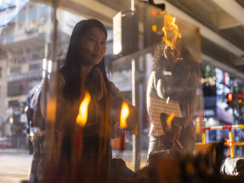 A customer prays during a 